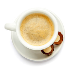 cup of coffee and candy on white background