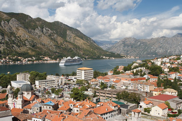 Naklejka na ściany i meble beautiful view of the old town and white cruise ship in the Bay of Kotor. Montenegro