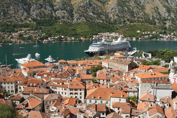 Naklejka na ściany i meble Top view of the old city and a cruise ship in port. Montenegro, Kotor
