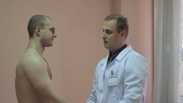 Young male athlete consulting a doctor.