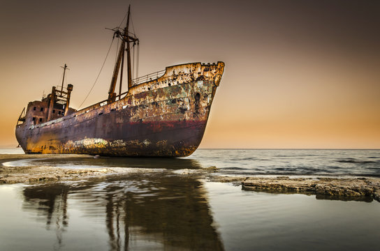 Rusty shipwreck on beach Greece