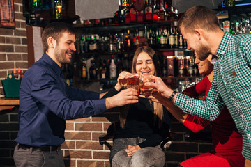 Two happy smiling young couples with champagne at celebration