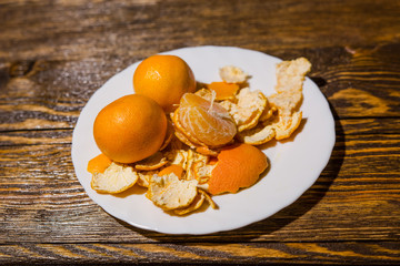 Tangerines lie on a white dish