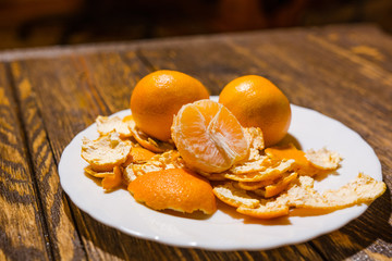 Tangerines lie on a white dish