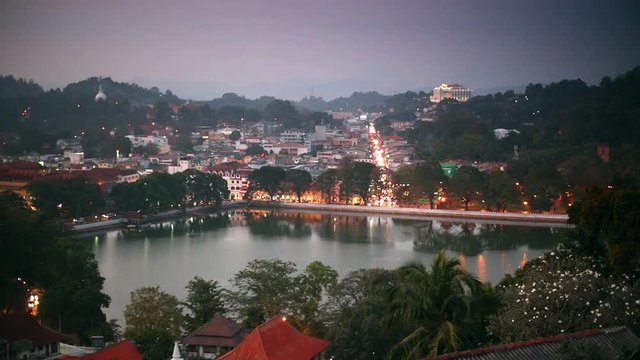 Panning shot of Kandy, Sri Lanka. City lights at dusk 
