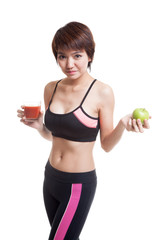 Beautiful healthy Asian girl with tomato juice and apple.