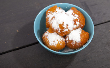 Traditional Dutch oliebollen on wooden background