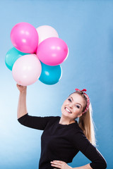 Teen joyful girl playing with colorful balloons