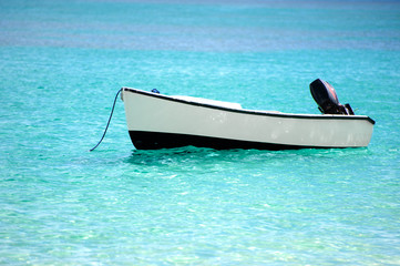 Boat in the laser ocean, moored near the shore in the Seychelles