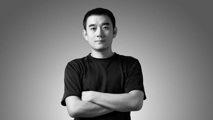 Black and white portrait of a young handsome asian man