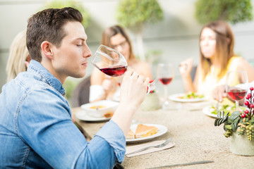 Handsome man drinking wine