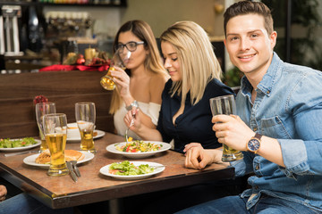 Young adults drinking beer in a restaurant
