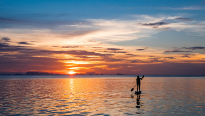 Girl on the paddleboard on the tropical island