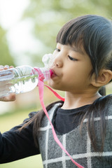 Kid drinking water from a bottle