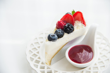 Cheese cake topped with mix berries and strawberry flavour 