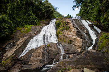 Fototapeta na wymiar Kundoormad Waterfall at Chalakkudi River and Vetilappara bridge