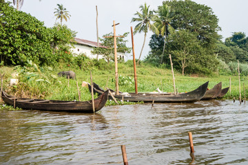 Wooden canoe on the shore with its motor