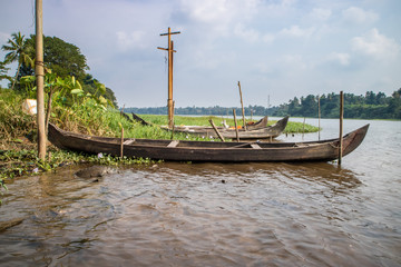 Fototapeta na wymiar Wooden canoe on the shore with its motor