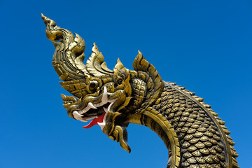 Fototapeta na wymiar Naga statue head with blue sky background.