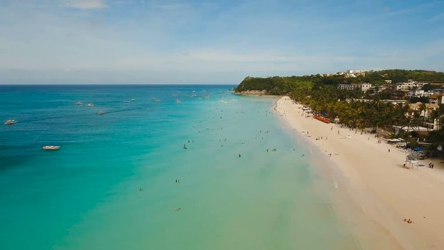 Aerial view of beautiful tropical island with white sand beach, hotels and tourists. Tropical lagoon with turquoise water and white sand. Beautiful sky, sea, beach, resort. Beautiful tropical beach of