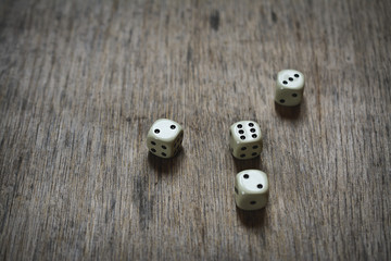 four dice on a wooden table. Business abstraction