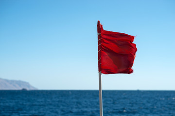 red flag at sea. Swimming is prohibited