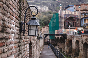 Street lantern on the wall of Ancient sulfuric Baths in Abanotubani district. Tbilisi, Georgia.