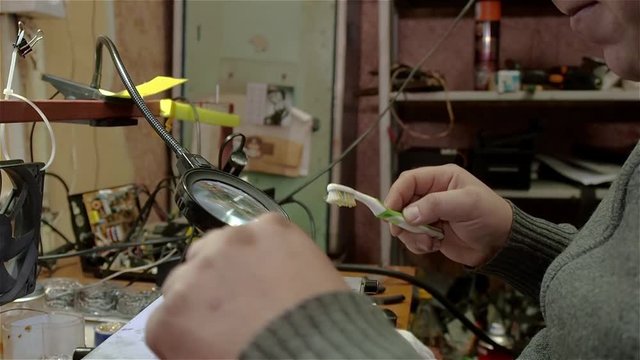 Engineer preparing motherboard of smartphone iphone to repair