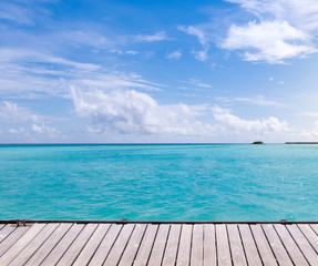 Fototapeta na wymiar Wooden floor with sea and blue sky background.