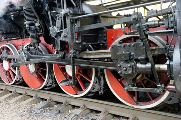 Fototapeta na wymiar Wheels of black steam locomotive Er-794-12 on railway