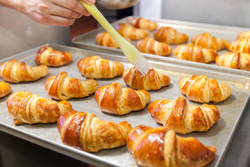 Detail of Hands preparing french croissant in colour