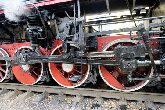 Wheels of black steam locomotive Er-794-12 on railway
