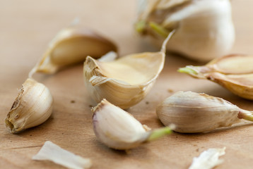 cloves of garlic on wooden plate 