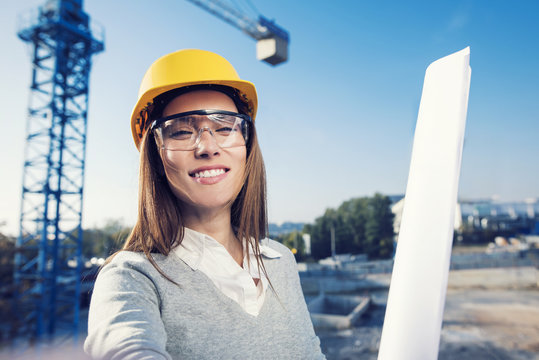 Beautiful Woman Civil Engineer Is Taking A Selfiet In Her Work In Front Of A Crane