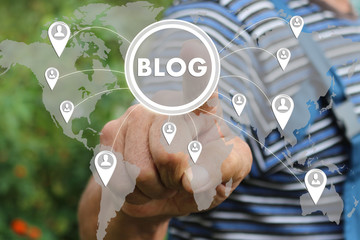 Farmer businessman clicks on the blog button on the touch screen. The home page of the blogs, social technology , writing website .Tanned hands, male hands of an elderly person.