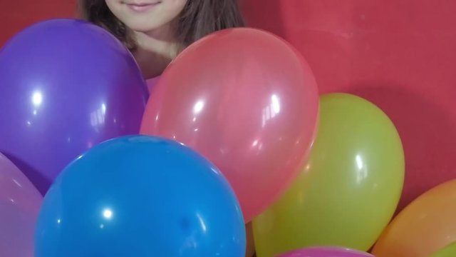 Girl playing with balloons.
