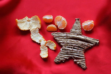 This is symbol of Christmas Holidays in Italy - white star, mandarin and red background