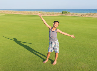 Happy children on summer gulf grass terrain having fun and happy