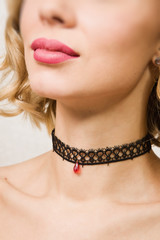 Beautiful woman showing her neck with a choker on it
