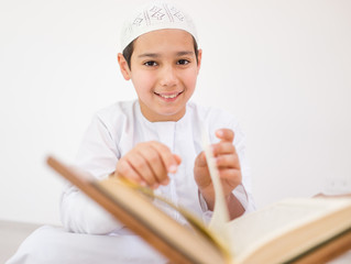 Happy kids reading Koran