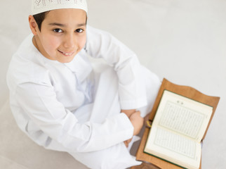 Happy kids reading Koran