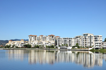 Fototapeta na wymiar Apartment living on a lake waterfront apartments on a lake showi