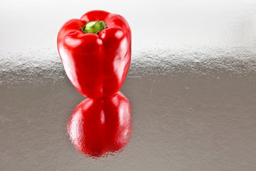 Red Capsicum on stainless steel bench
