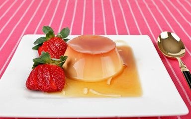 Creme caramel dessert with strawberries