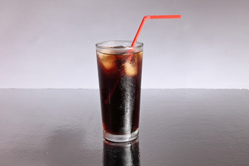 Cola soft drink with ice and straw