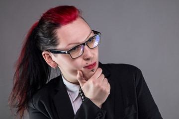 Thinking business punk woman in glasses