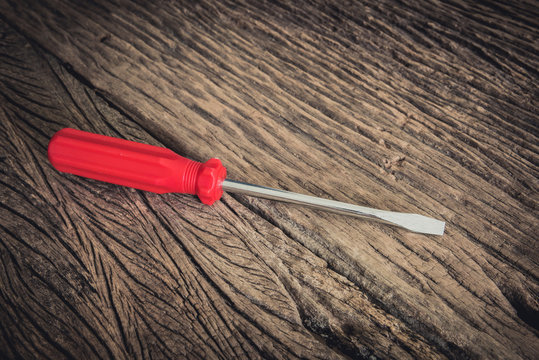 Red Screwdriver On Wooden Background