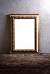 luxurious photo frame on wooden table over grunge background