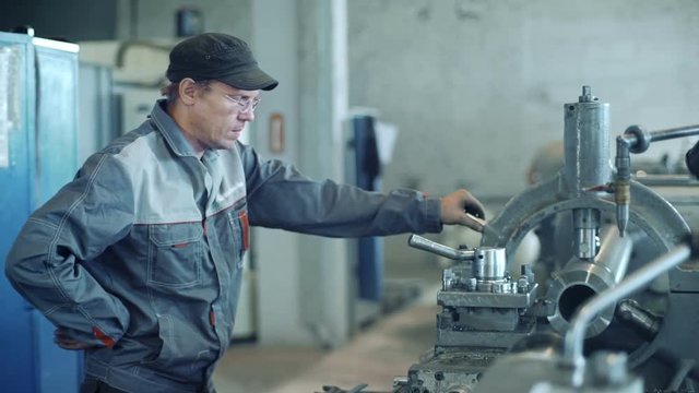 Industrial worker operating milling machine