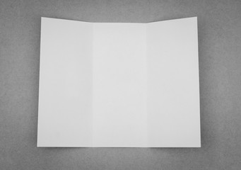 Trifold white template paper on gray background .
